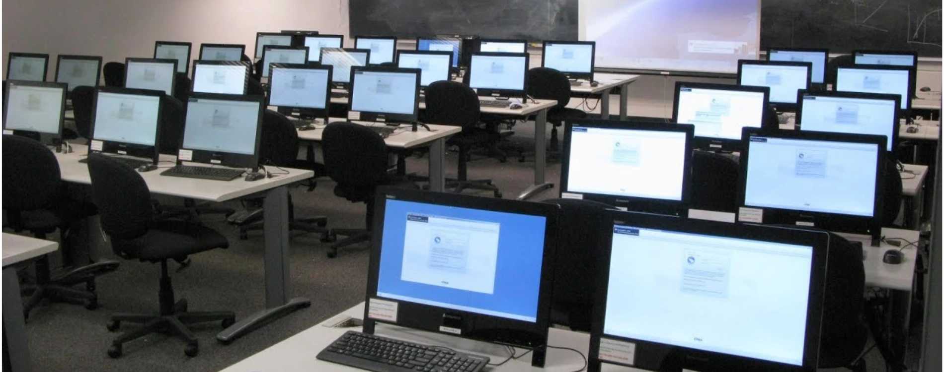 Students working on computers in a school lab learning digital literacy and coding skills