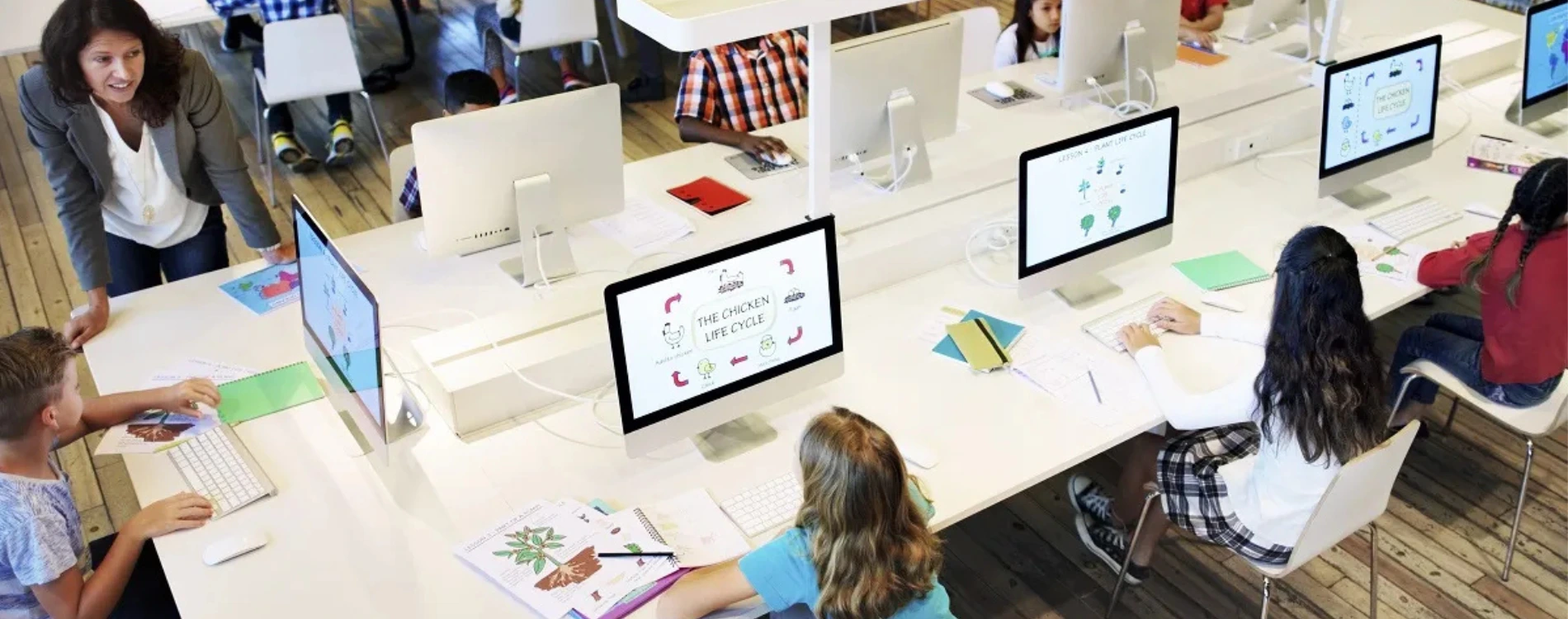 Students using tablets and laptops in a classroom as part of online learning integration in school education